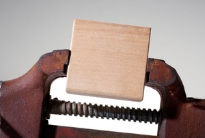 A vise with a block of wood inbetween.