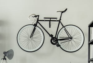 bike mounted on wall rack near shelves
