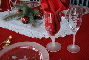 Holiday table setting with etched glassware.