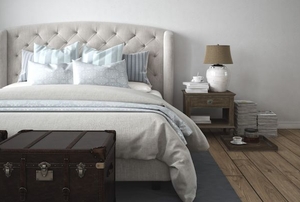 beige furniture including a bed frame, chest, and nightstand in a bedroom