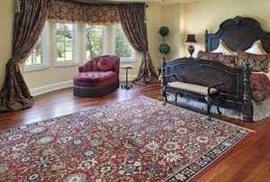 a well appointed bedroom with a Persian rug