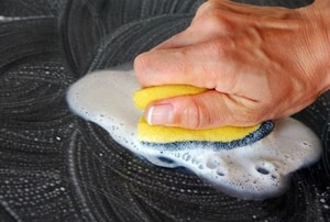 Use a sponge and detergent to scrub paint from plastic.