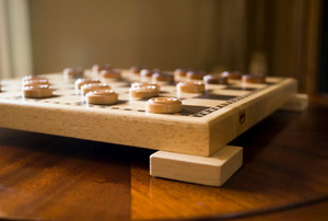 A checker board on a cool coffee table.