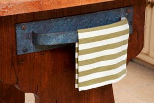 A kitchen towel hanging on a vintage handle