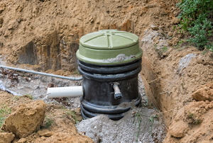 An unburied grinder pump holding tank.