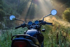 front of a motorcycle with nature in the background