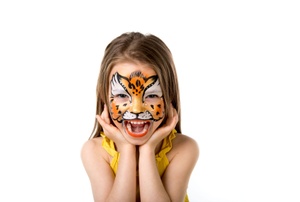 A girl with tiger face paint on a white background.