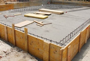 house with foundation being built