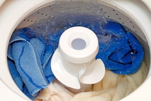 A washing machine filling with water in preparation for a cycle.