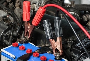 jumper cables attached to a car battery