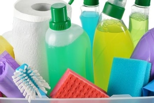 basket of colorful home cleaning products and tools