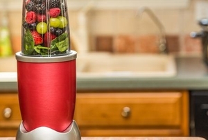 small blender filled with fruit