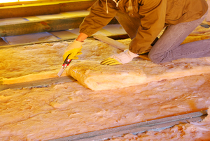 man installing batt insulation