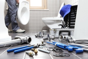 A toilet surrounded by tools.
