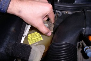a hand on a Radiator Cap