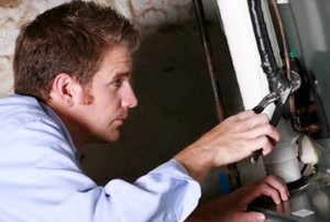 man working on a gas furnace