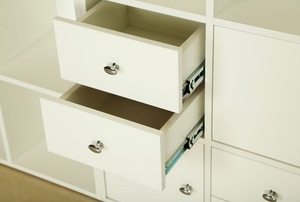 A set of offwhite cabinets with two drawers slightly open