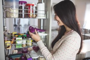 Woman looking at a food item from a pull out pantry