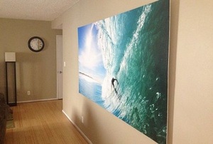 A mural of a surfer hanging on an apartment wall.