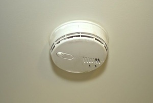 A smoke and carbon monoxide detector on the ceiling.