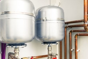 Boilers on a white wall.
