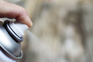 closeup of someone spraying a can of spray paint