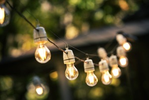 A string of outdoor lights with lit bulbs.
