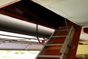 A metal ladder leading up to an above-garage storage area.