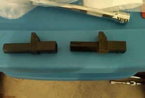 Two position sensors set side-by-side on top of a work area.