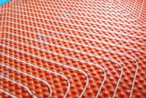 tubes of radiant floor heating under a floor space