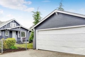 separate garage next to a house, both painted blue and white