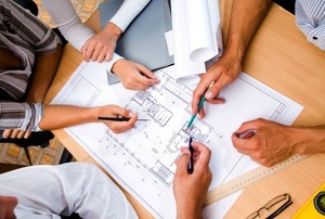Going over renovation plans with an architect and engineer.