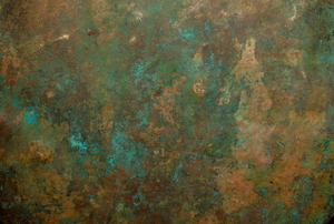 A sheet of copper with bluish green buildup on the surface.