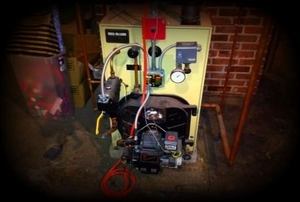 A steam boiler in a basement.