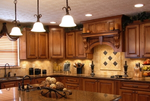 kitchen with drop lights and dark cabinets