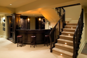 carpeted stairs leading out of a room with a dark-colored bar