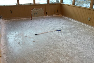 A hockey rink on an inclosed porch.