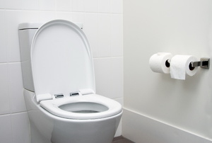 An open toilet in a white bathroom.