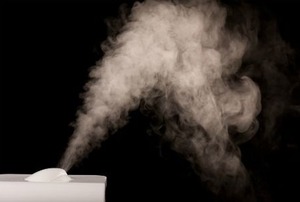 A portable humidifier releasing moisture into the air.