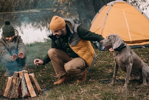 man, child, and dog camping