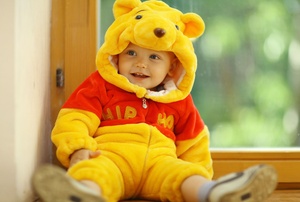 A kid in a Winnie the Pooh costume.