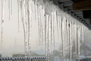 A row of icicles hanging off a roof. 