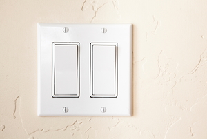 A contemporary style dual light switch on a wall.