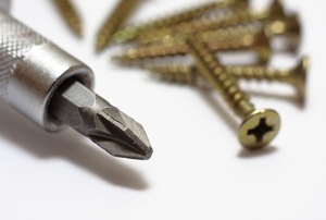 A crosshead or Phillips head screwdriver and screws.