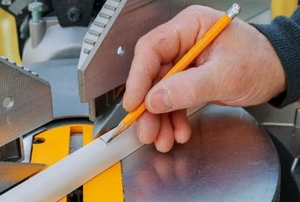 hand measuring an angle with a saw