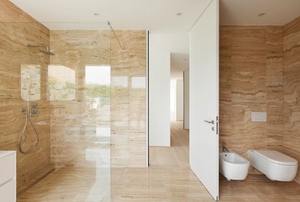 a sleek modern bathroom with smooth stone surfaces