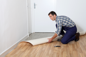 Man working with linoleum flooring