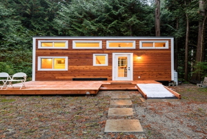 A wood paneled tiny home in the forest