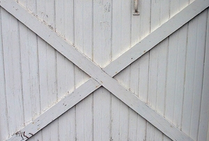 A distressed white wood fence.