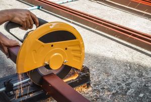 A man uses a circular saw.